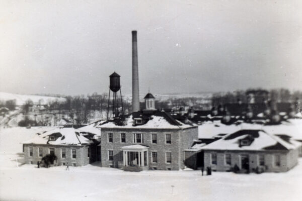 The completed factory and office building in the snow.