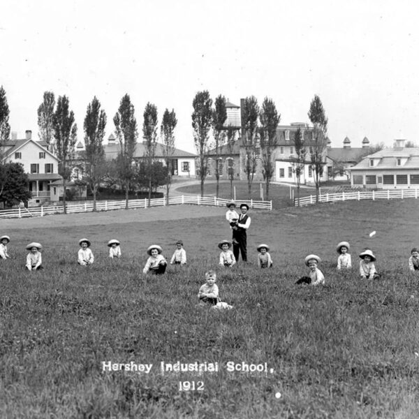 Copenhaver at the Hershey Industrial School with the boys in a field.