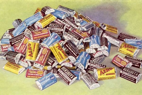 Pile of Hershey's Miniatures chocolate bars on a green background